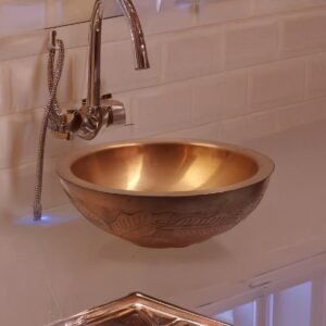 Handmade hammered copper vessel sink with engraved detailing for luxury bathroom interiors