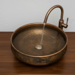 Handcrafted round copper vessel sink with antique hammered finish and elegant faucet