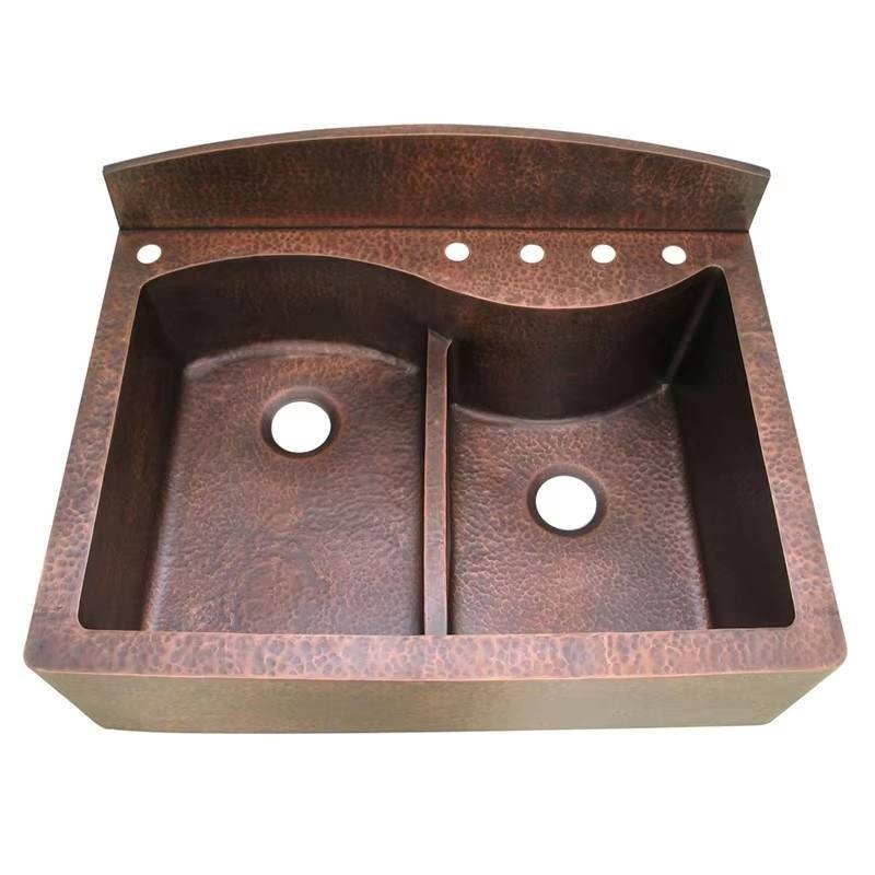 Textured copper farmhouse sink with twin basins and integrated rear faucet ledge