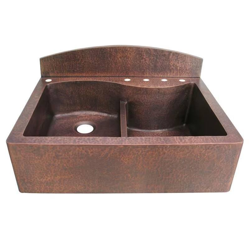 Antique copper double basin sink with hand hammered texture and raised faucet panel