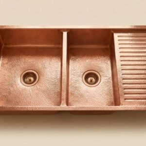 Handcrafted double bowl copper kitchen sink with integrated drainboard and hammered finish